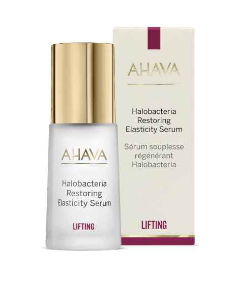 AHAVA Halobacteria Restoring Elasticity Serum in weißer Flasche mit goldener Kappe und passender Verpackung im Hintergrund.