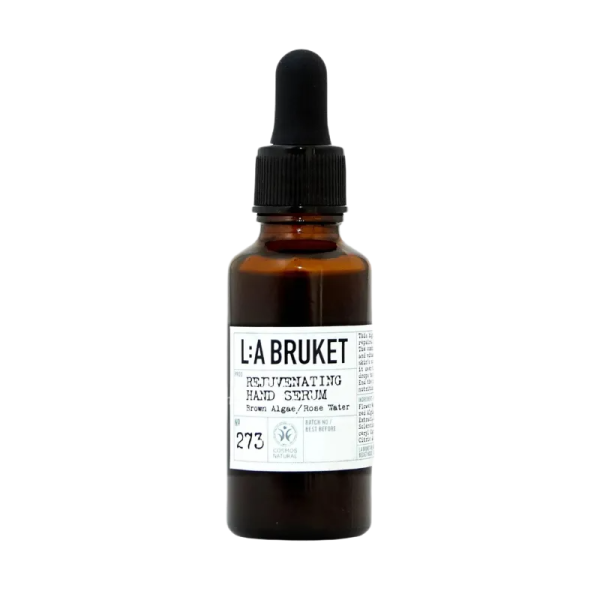 Braunes Glasfläschchen mit Pipette, beschriftet mit 'L:A BRUKET Rejuvenating Hand Serum No. 273'.