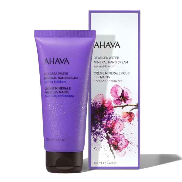 AHAVA Mineral Handcreme Spring Blossom, 100 ml, lila Tube neben Verpackung mit Blumenmuster.