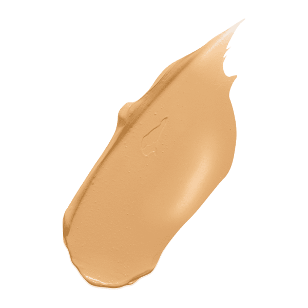 Beige Concealer-Swatch auf grünem Hintergrund.