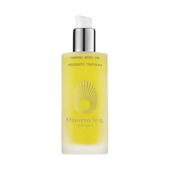 Flasche mit Omorovicza Firming Body Oil, gelbe Flüssigkeit, silberner Spender, ungarischer Text.